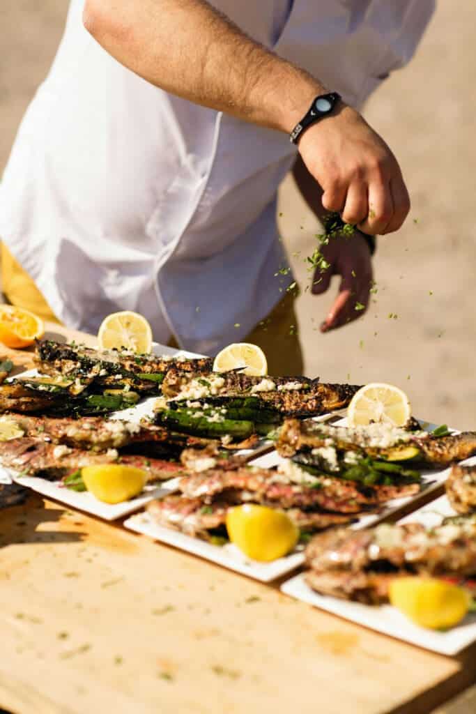 Grilled oysters with lemon wedges served for a group meal