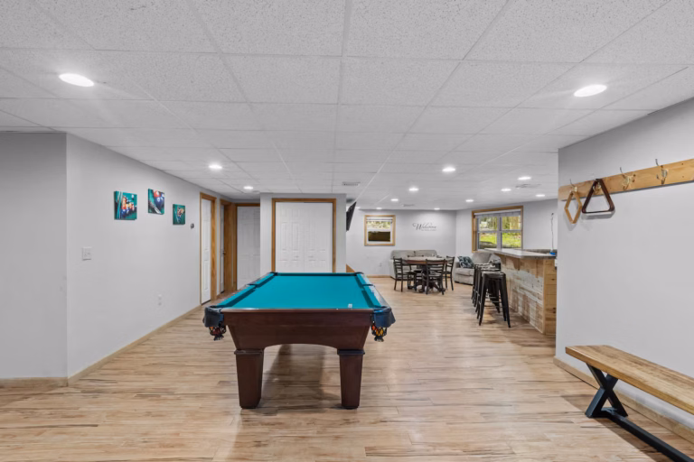 Game room with a pool table and a bar-height dining area