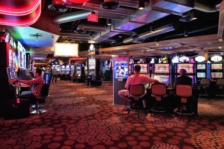 Visitors on a busy casino floor with slot machines