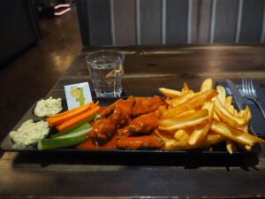 A plate of chicken wings and fries, classic bar food