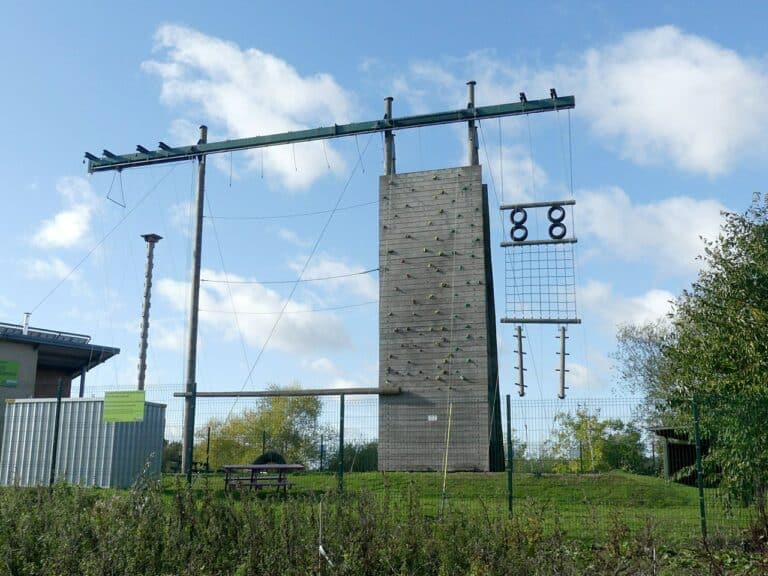 Climbers on a high ropes course among the trees